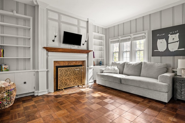 living room featuring a fireplace and built in shelves