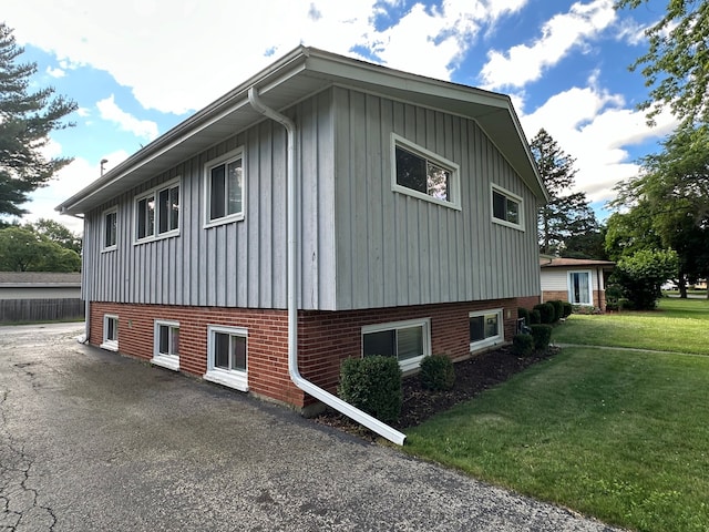 view of property exterior featuring a lawn