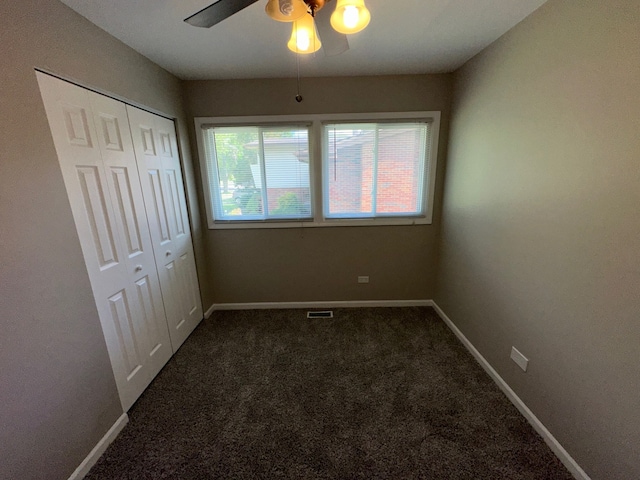 unfurnished bedroom featuring ceiling fan, a closet, and carpet flooring