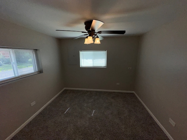 carpeted empty room with a healthy amount of sunlight and ceiling fan