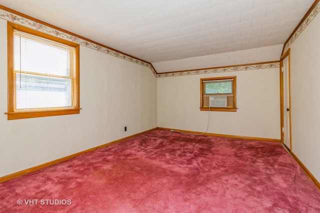 empty room with carpet floors, lofted ceiling, and ornamental molding