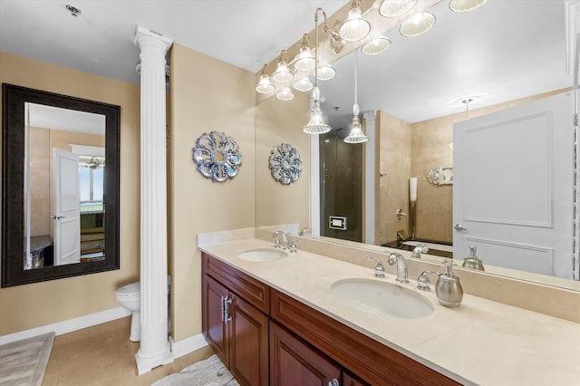 bathroom with decorative columns, vanity, toilet, and tile patterned floors