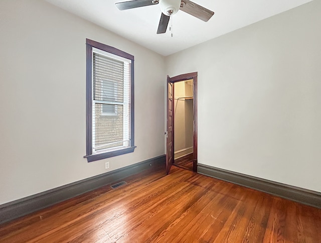 unfurnished room with ceiling fan and wood-type flooring