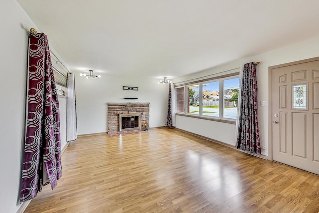 unfurnished living room with a fireplace and light hardwood / wood-style floors