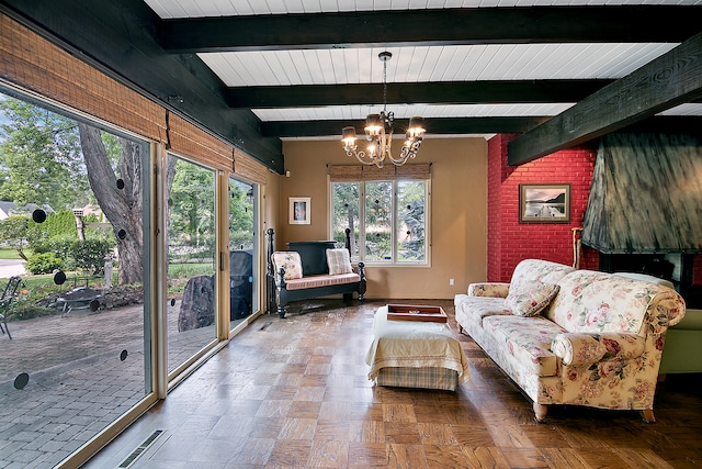 living room with a chandelier, parquet flooring, and beam ceiling