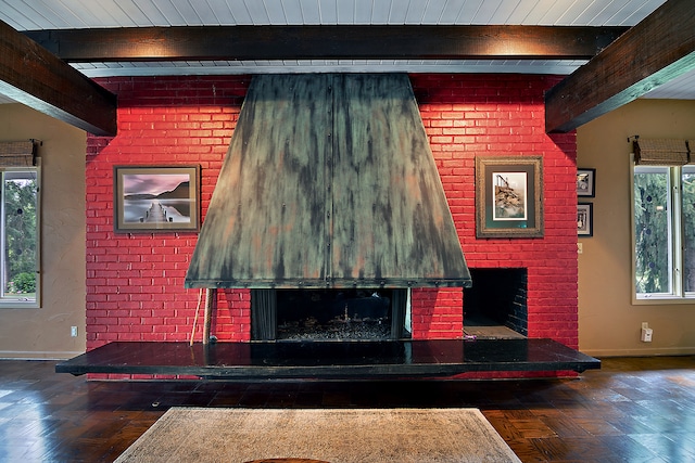 living room featuring a fireplace, plenty of natural light, and beam ceiling