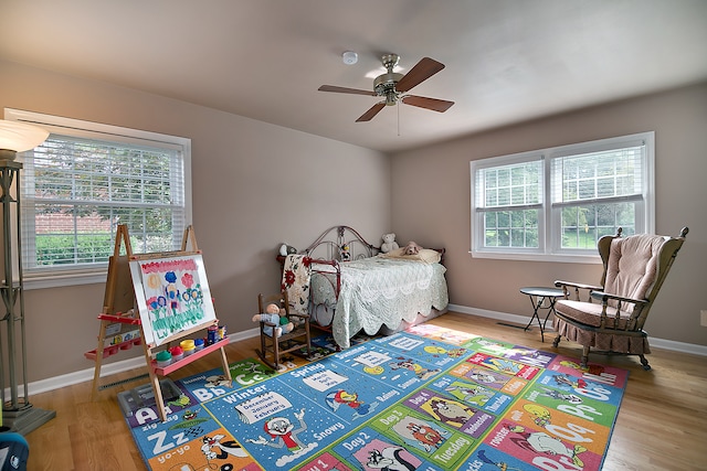 bedroom with ceiling fan and wood-type flooring