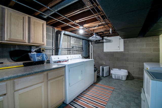 washroom with washer and dryer and cabinets