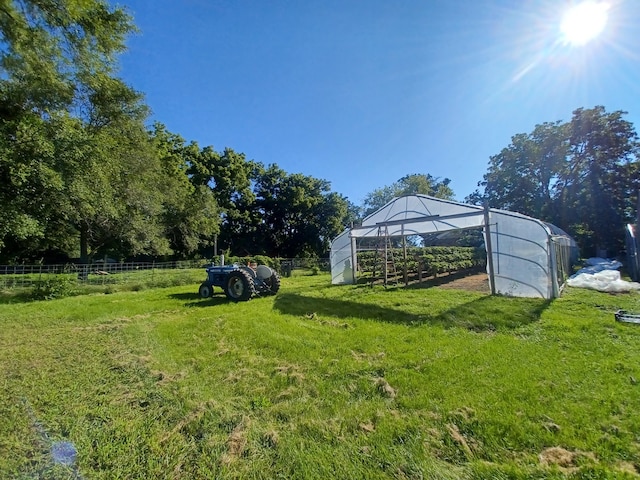 view of yard featuring an outbuilding and a rural view