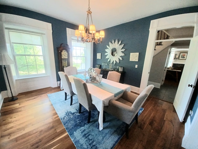 dining space with an inviting chandelier and dark hardwood / wood-style floors