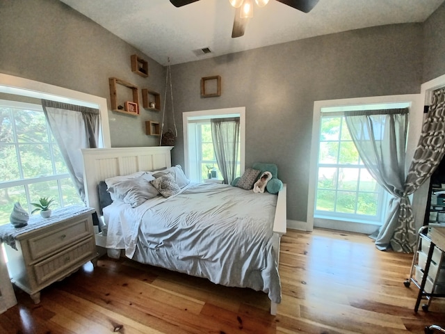 bedroom featuring wood-type flooring, lofted ceiling, and ceiling fan