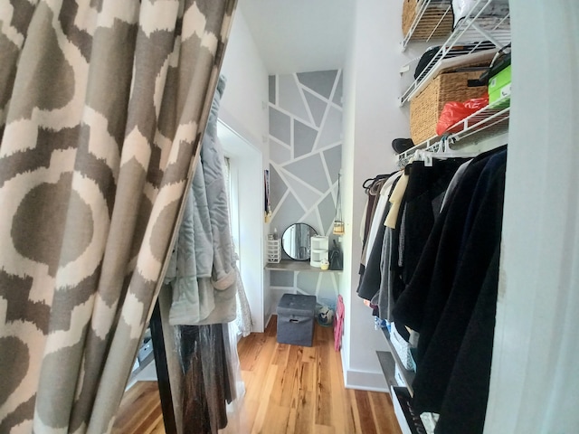 spacious closet with hardwood / wood-style floors