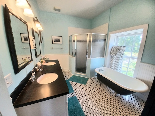 bathroom with vanity, plus walk in shower, and tile patterned flooring