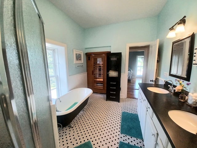 bathroom featuring independent shower and bath, vanity, and wood-type flooring