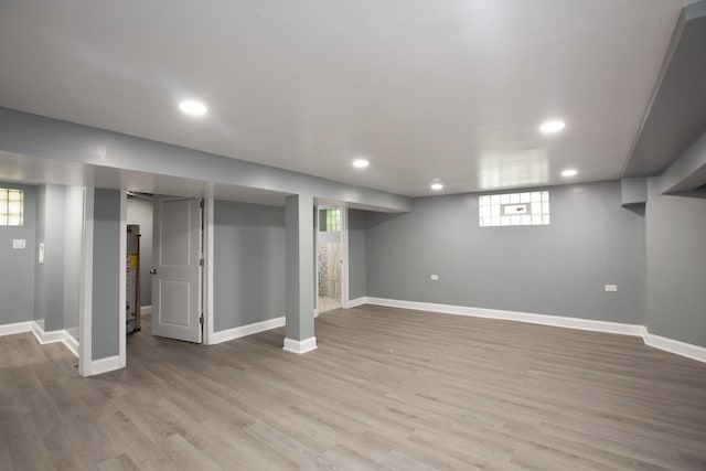 below grade area with recessed lighting, light wood-style floors, and baseboards