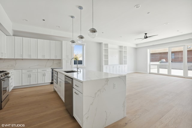 kitchen with stainless steel appliances, wine cooler, white cabinetry, light wood-type flooring, and hanging light fixtures