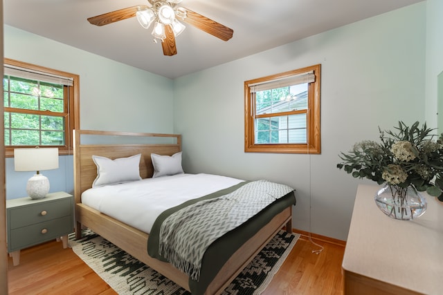 bedroom with light wood-type flooring and ceiling fan