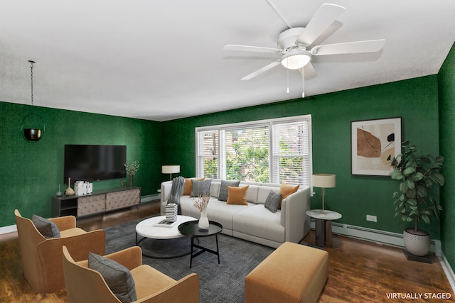 living room featuring dark hardwood / wood-style flooring, baseboard heating, and ceiling fan