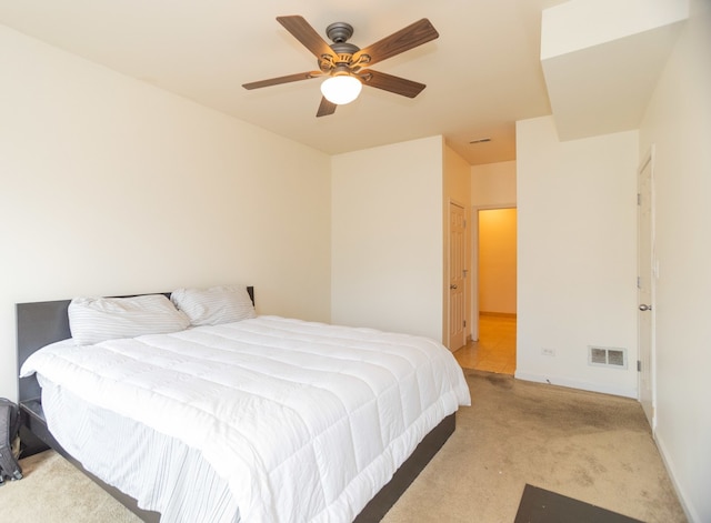 bedroom with ceiling fan, a closet, and light carpet