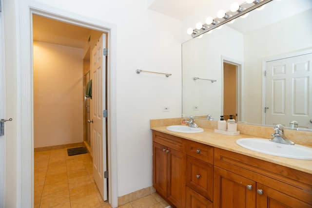 bathroom with tile patterned flooring and dual vanity