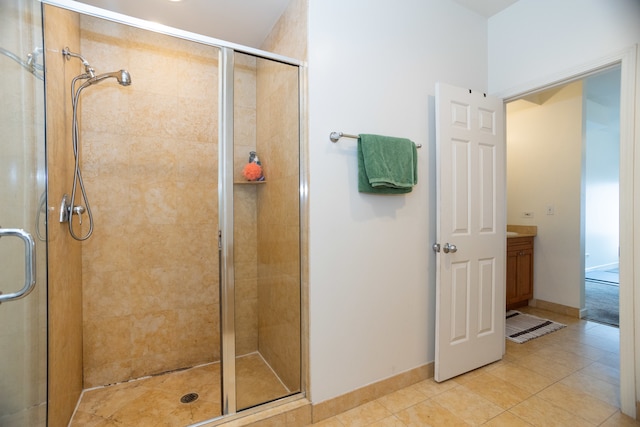 bathroom with vanity, tile patterned floors, and a shower with shower door