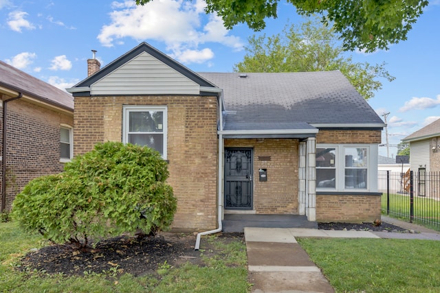 bungalow-style home featuring a front lawn