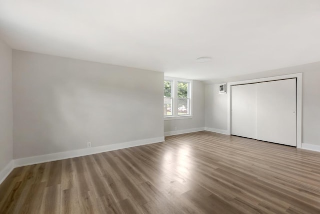 unfurnished bedroom featuring hardwood / wood-style floors and a closet