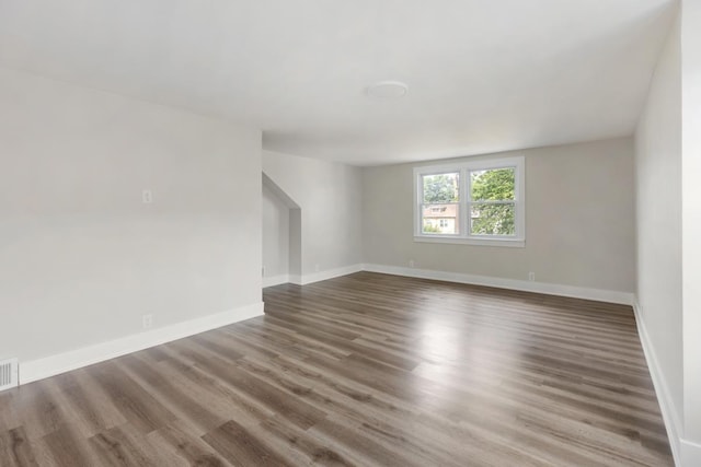 spare room featuring dark hardwood / wood-style flooring