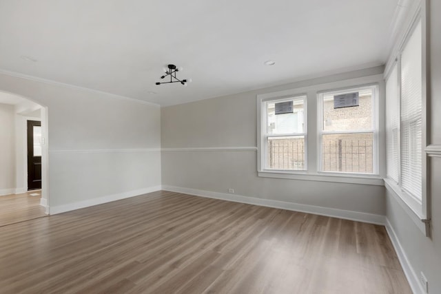 unfurnished room featuring crown molding and hardwood / wood-style floors