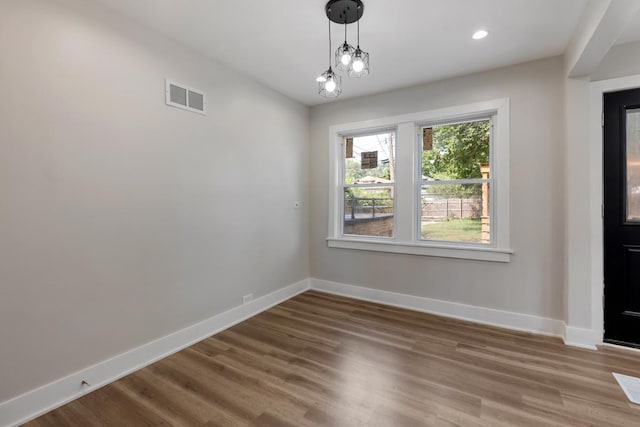 unfurnished dining area with hardwood / wood-style floors