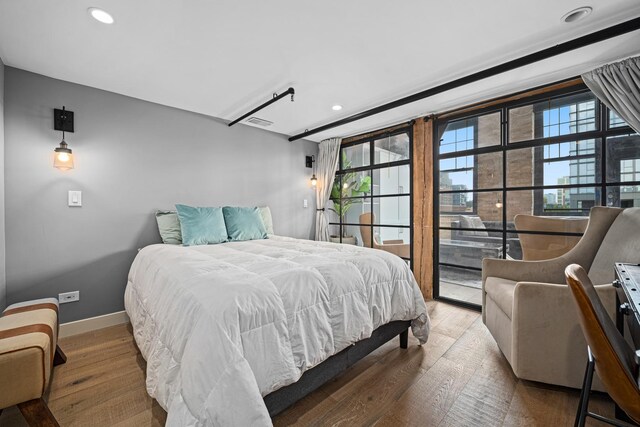 bedroom with hardwood / wood-style flooring