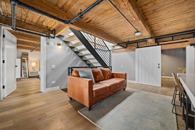 living room featuring wooden ceiling, beam ceiling, and light hardwood / wood-style floors