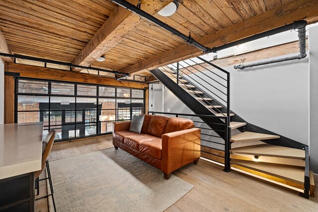 sitting room featuring wood ceiling, beam ceiling, and light hardwood / wood-style floors