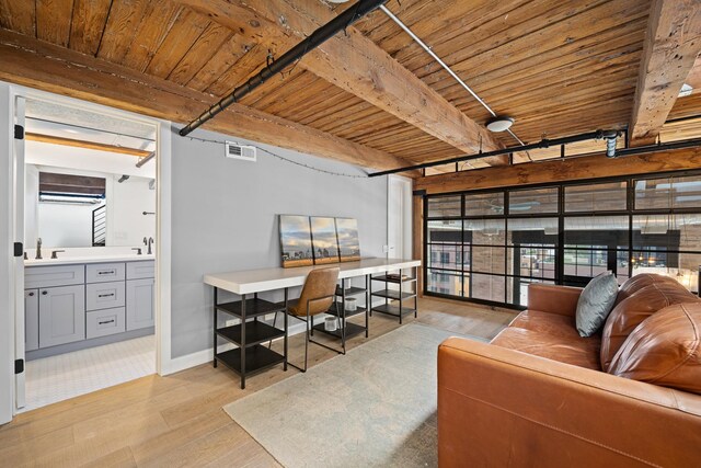 home office with wooden ceiling, light hardwood / wood-style flooring, beam ceiling, and sink