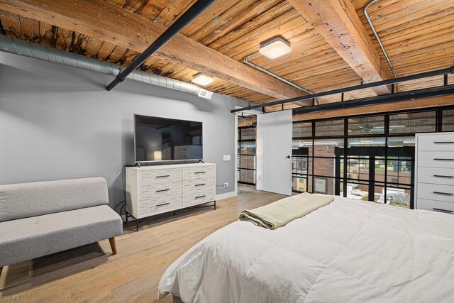 bedroom with wood ceiling, beamed ceiling, and light hardwood / wood-style floors