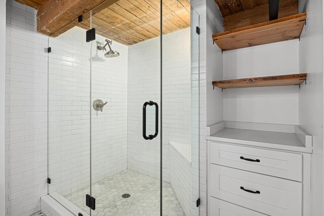 bathroom featuring wood ceiling and a shower with shower door