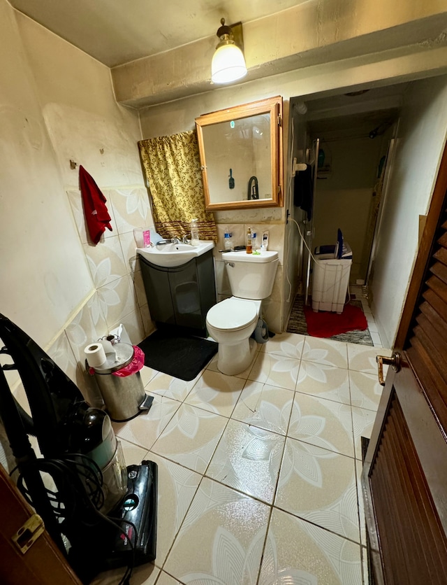 bathroom with tile patterned flooring, toilet, and vanity