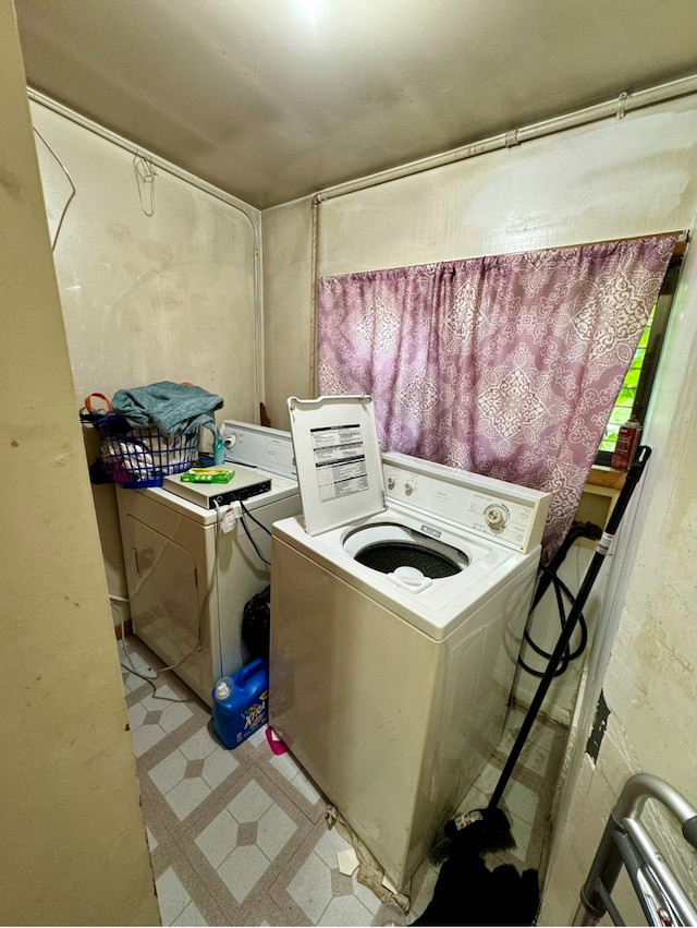 laundry room featuring separate washer and dryer and light tile patterned floors