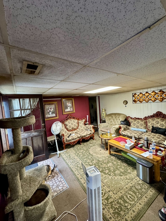 living room featuring a paneled ceiling