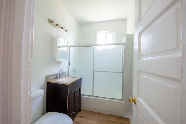 bathroom with toilet, wood finished floors, and vanity