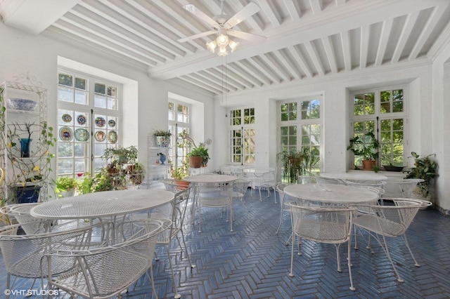 sunroom / solarium featuring beam ceiling