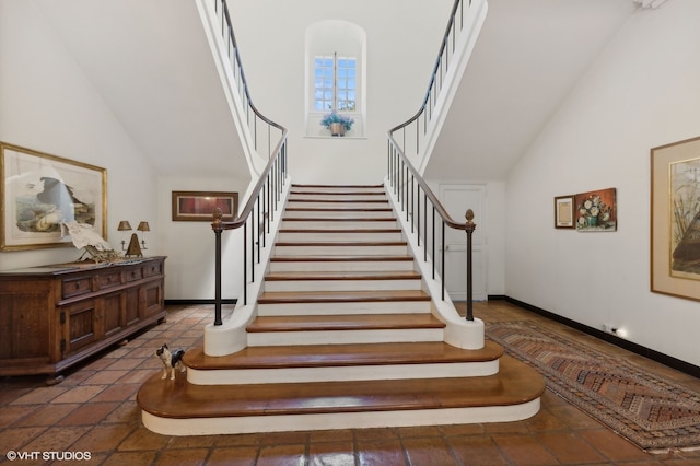 stairway with high vaulted ceiling