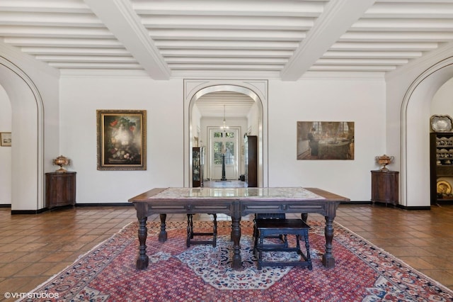 tiled dining space featuring arched walkways, baseboards, and beamed ceiling