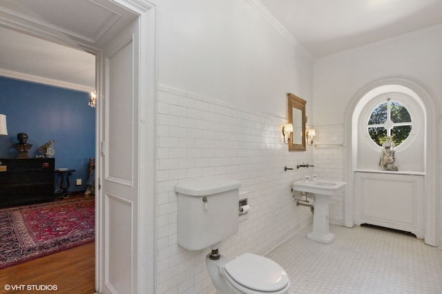 bathroom with ornamental molding, tile walls, toilet, and hardwood / wood-style floors