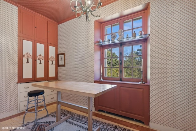 office area featuring a chandelier, wood finished floors, and wallpapered walls