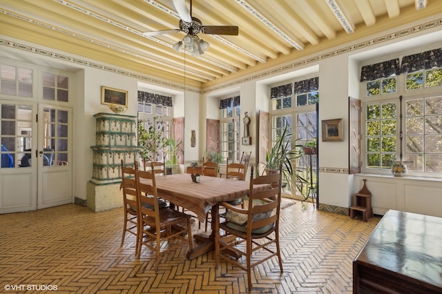 sunroom / solarium with ceiling fan, beamed ceiling, and french doors