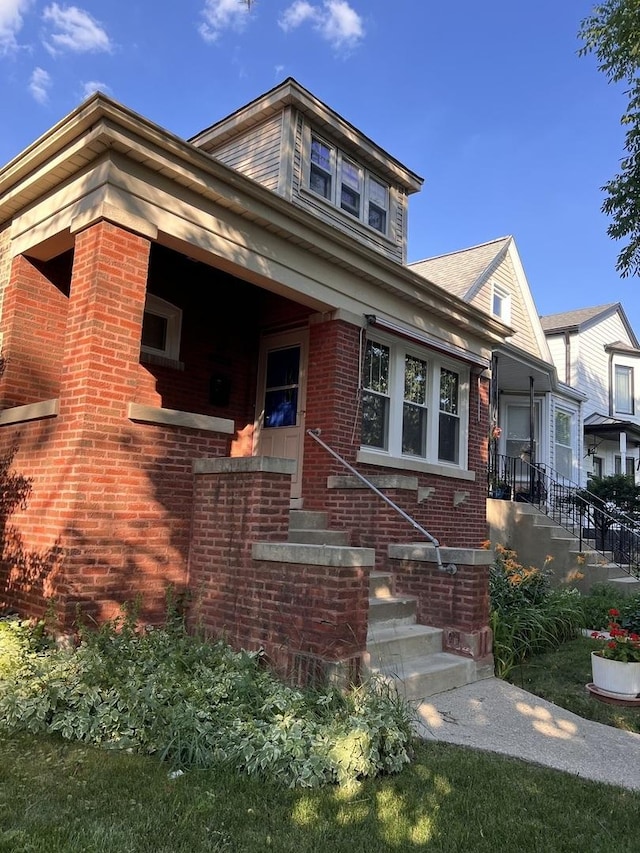 view of front of home featuring brick siding