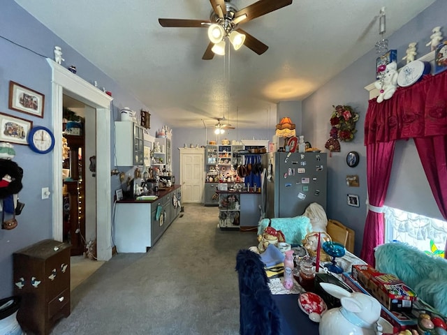 dining area with carpet floors, sink, and ceiling fan