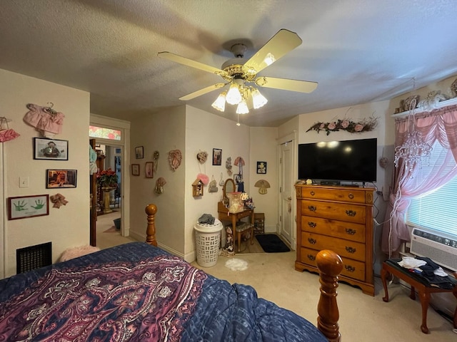 carpeted bedroom with cooling unit, ceiling fan, and a textured ceiling