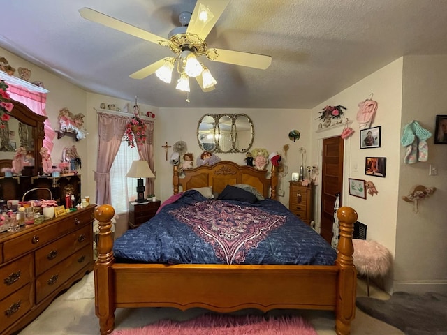 carpeted bedroom with ceiling fan and a textured ceiling